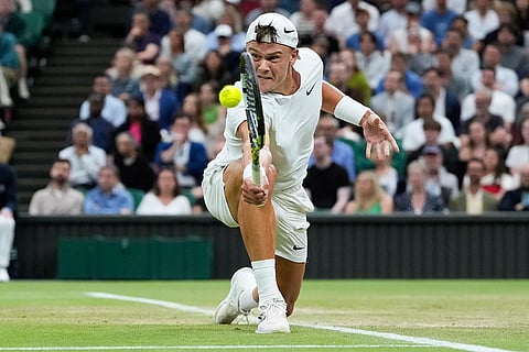 Holger Rune plays a return to Novak Djokovic